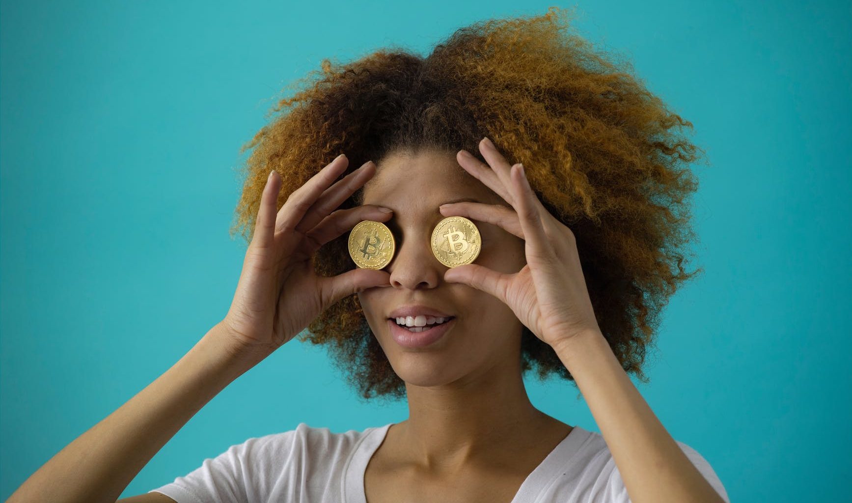 woman holding two coins