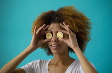 woman holding two coins